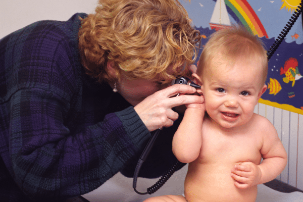 pediatrician looking in a child's ears