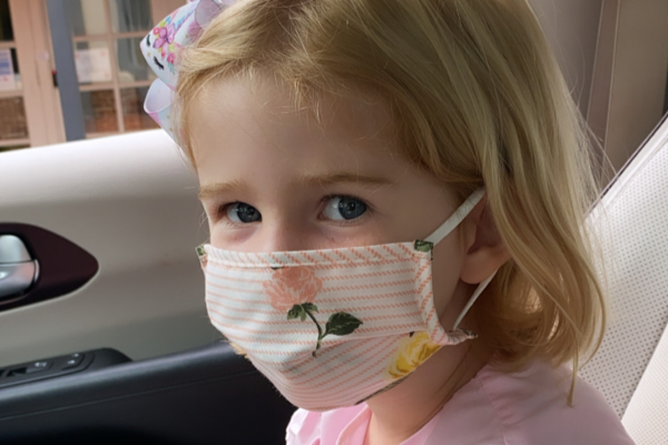 little girl in a mask