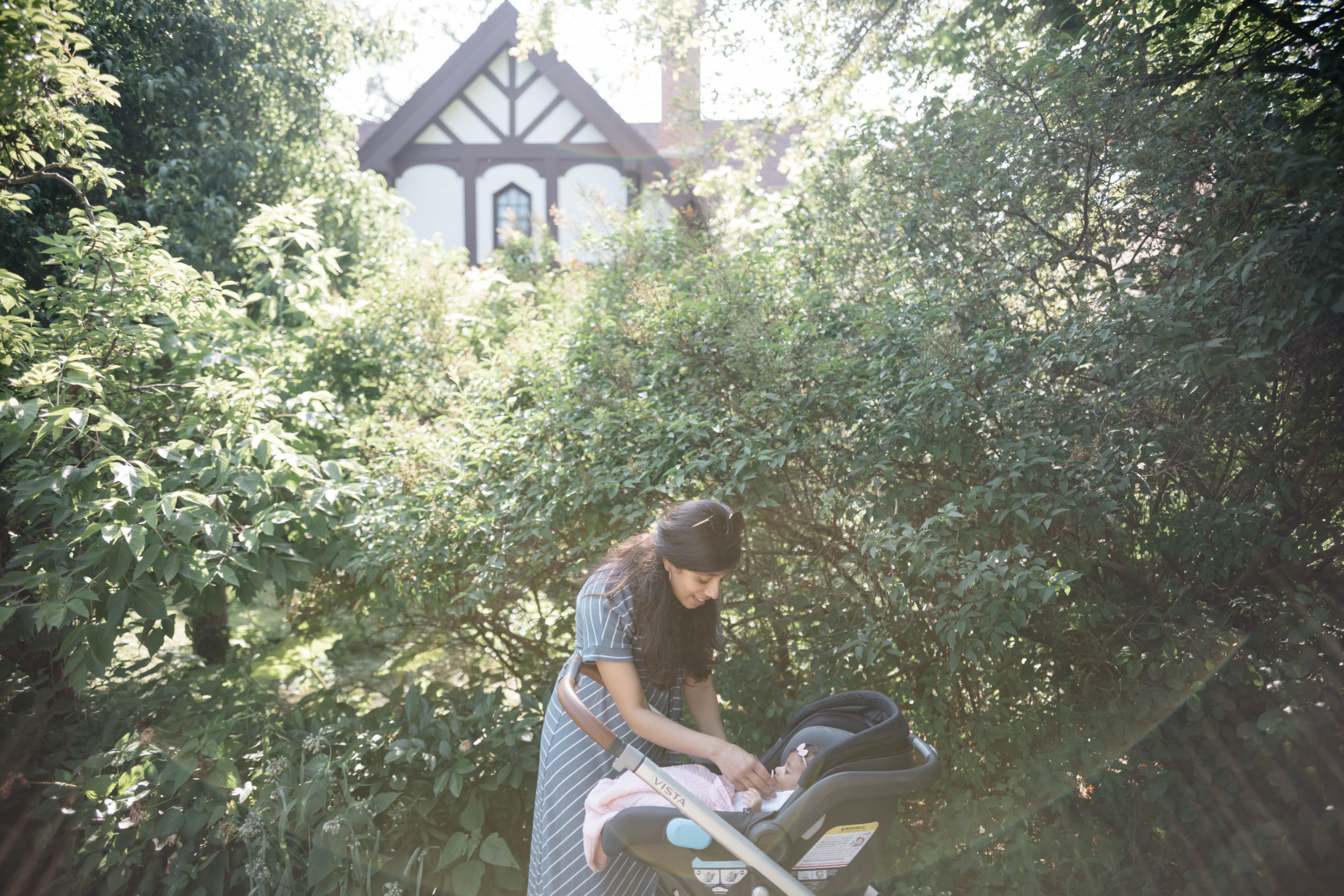 woman tending to baby in stroller