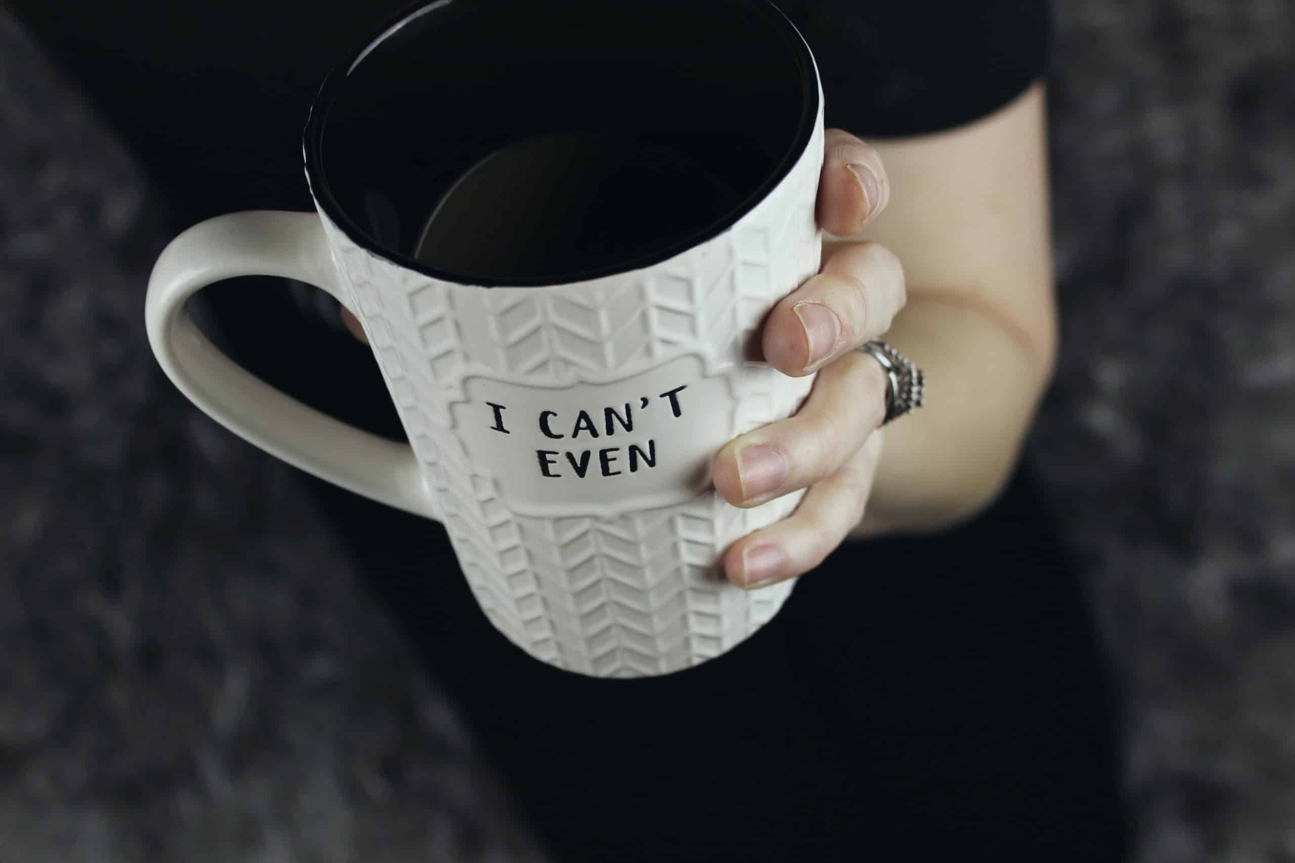 picture of a white mug with "I can't even" written on it, coffee is life for a hot mess mama