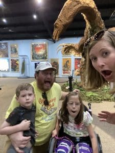 Family acting scared of a dinosaur replica 