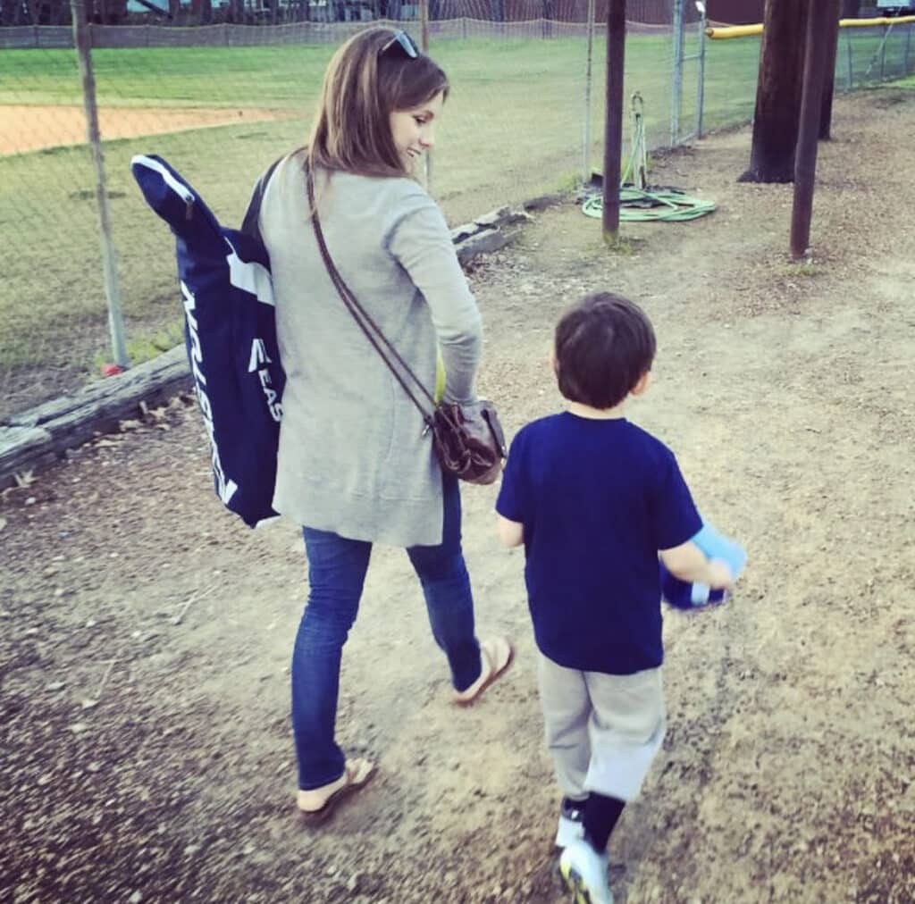 stepmom with son walking to baseball pratice