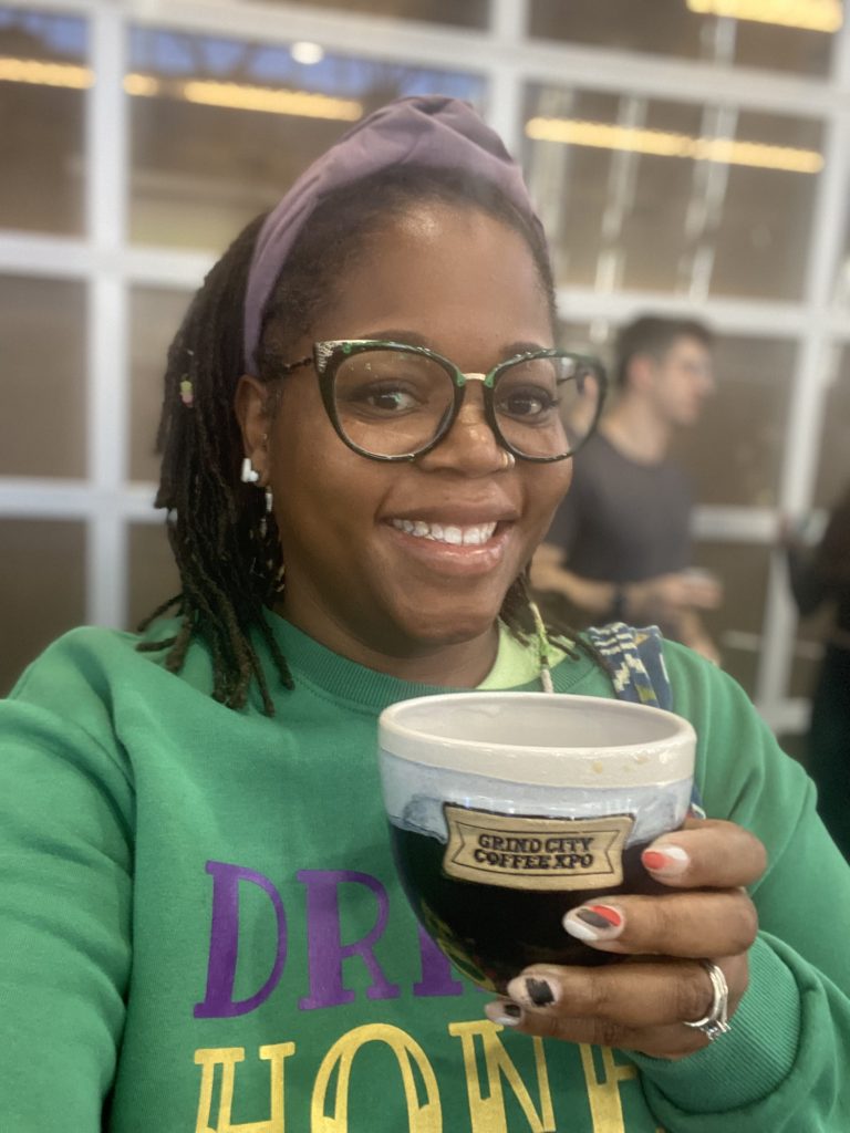 Patricia holding a coffee mug