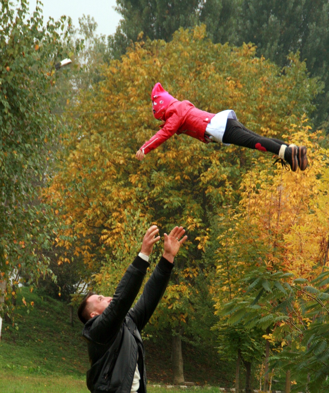 dad throwing their child in the air