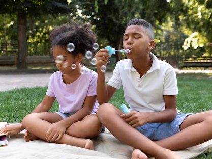 kids blowing bubbles in summer