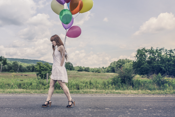 woman sad about her birthday with balloons