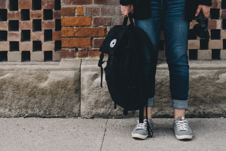 middle school holding backpack