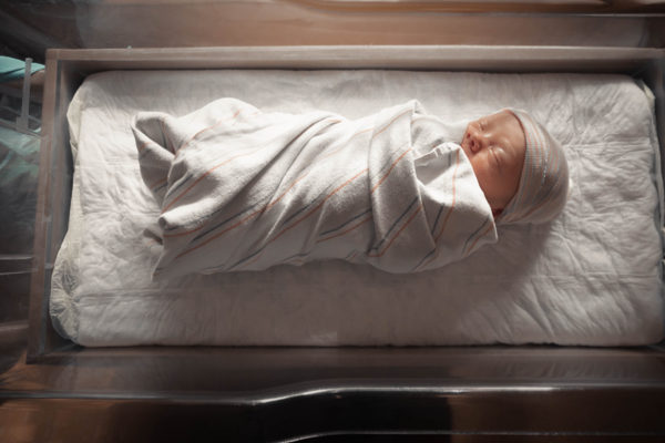 newborn in hospital bed