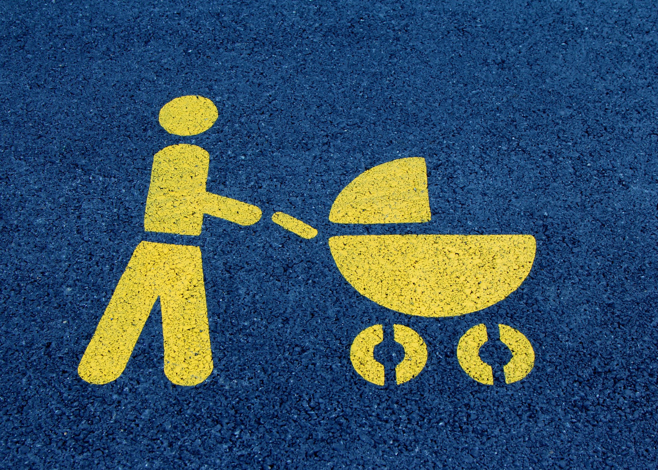 Painted street icon of person pushing a stroller
