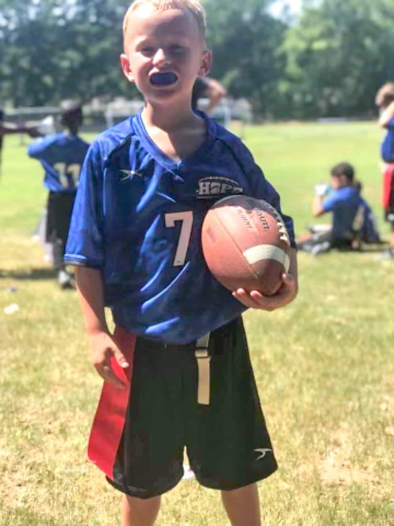 boy playing flag football