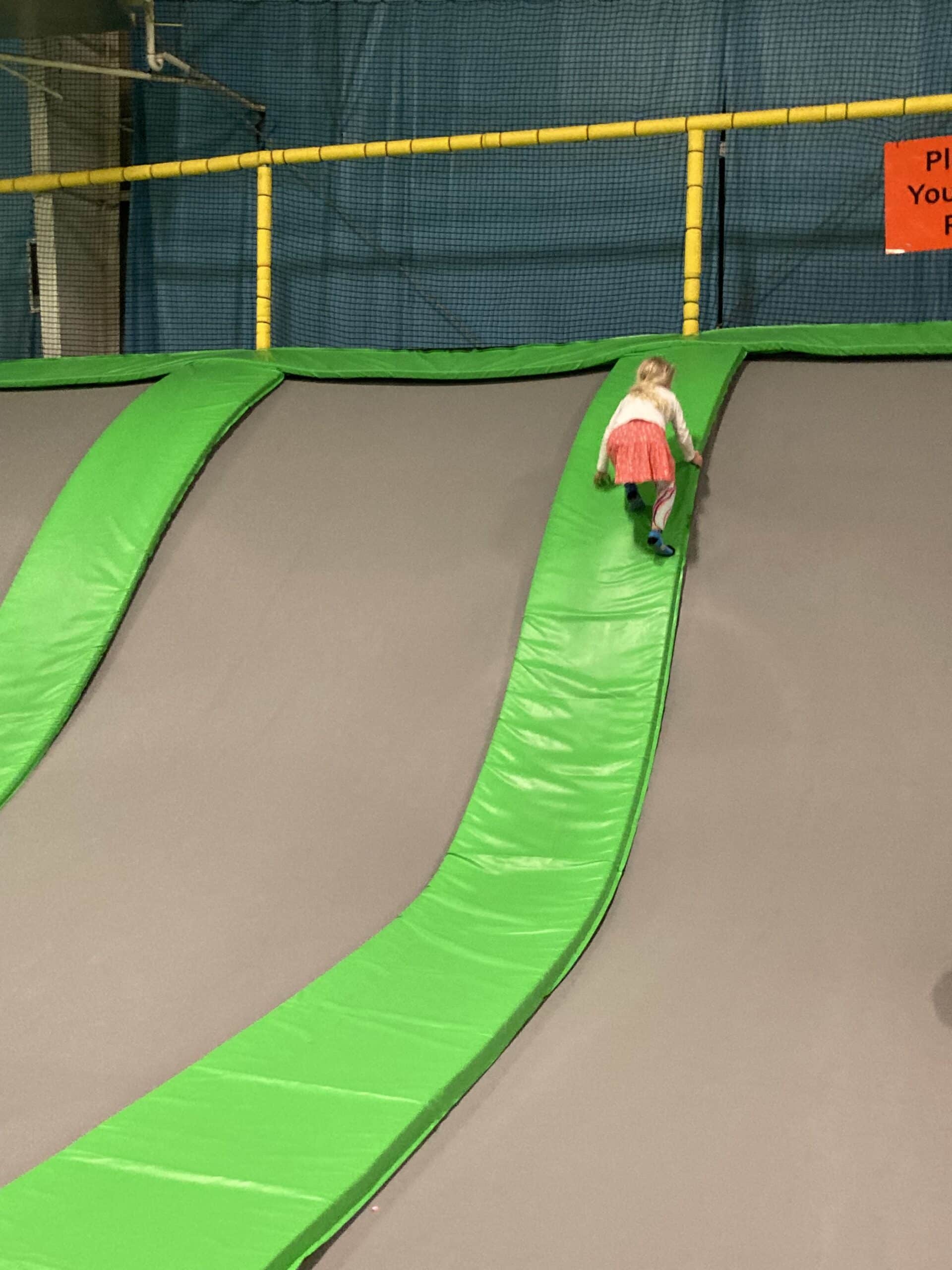 Climbing up a slide at Jumping World