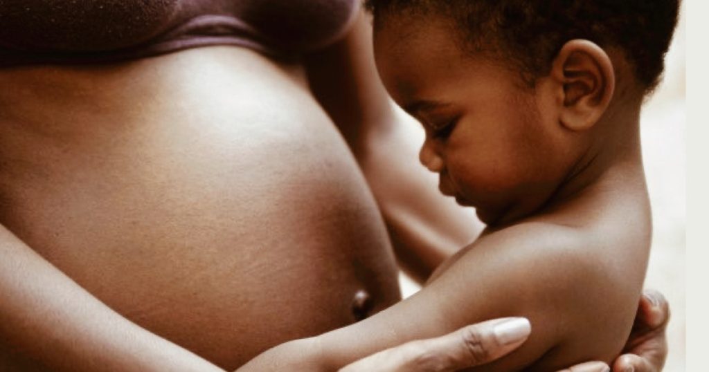 woman holding baby OBGYN guide