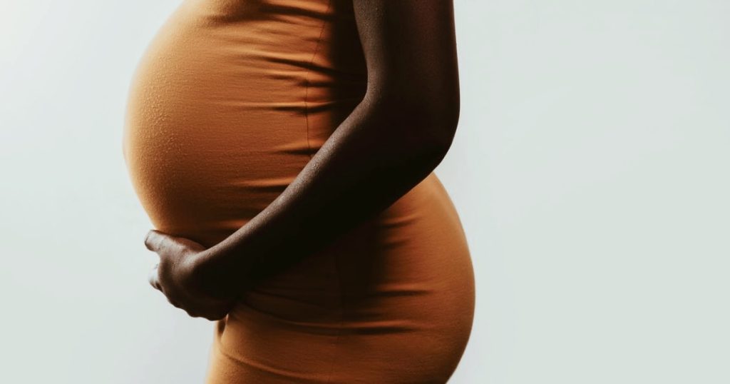 woman holding her pregnany belly