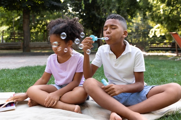 kids blowing bubbles in summer