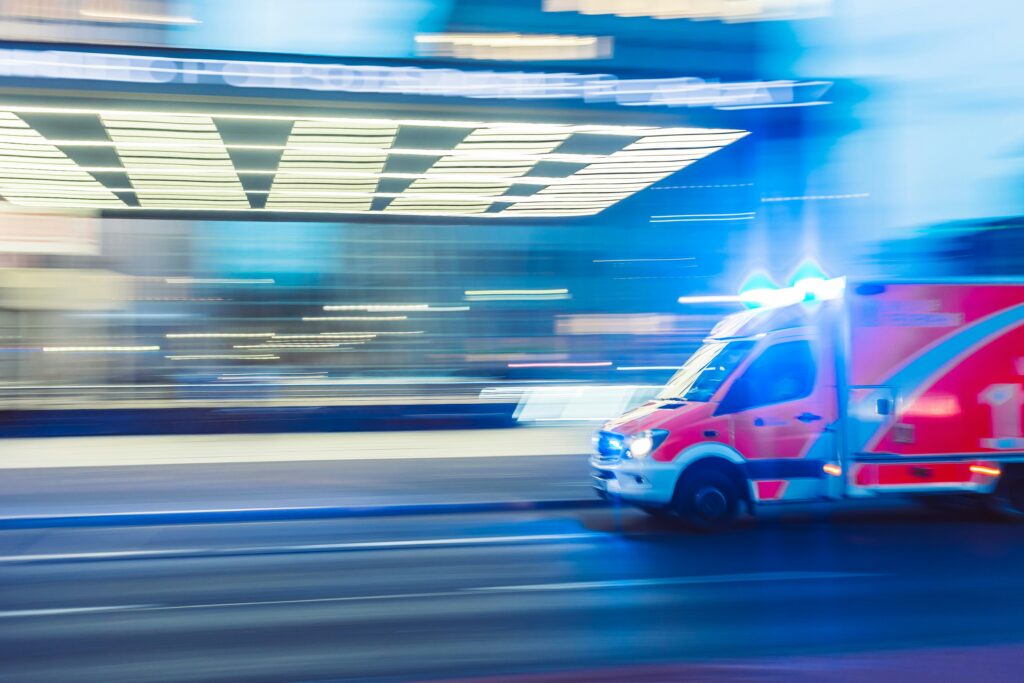 ambulance in front of a hospital going fast taking a patient with birth trauma