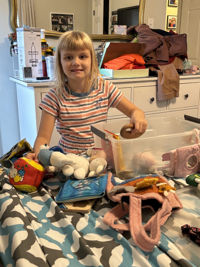 preparing for a sibling by helping organize toys