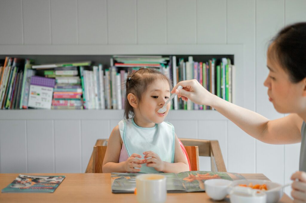 mom feeding her toddler