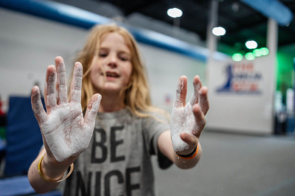 chalk on hands at the ninja gym