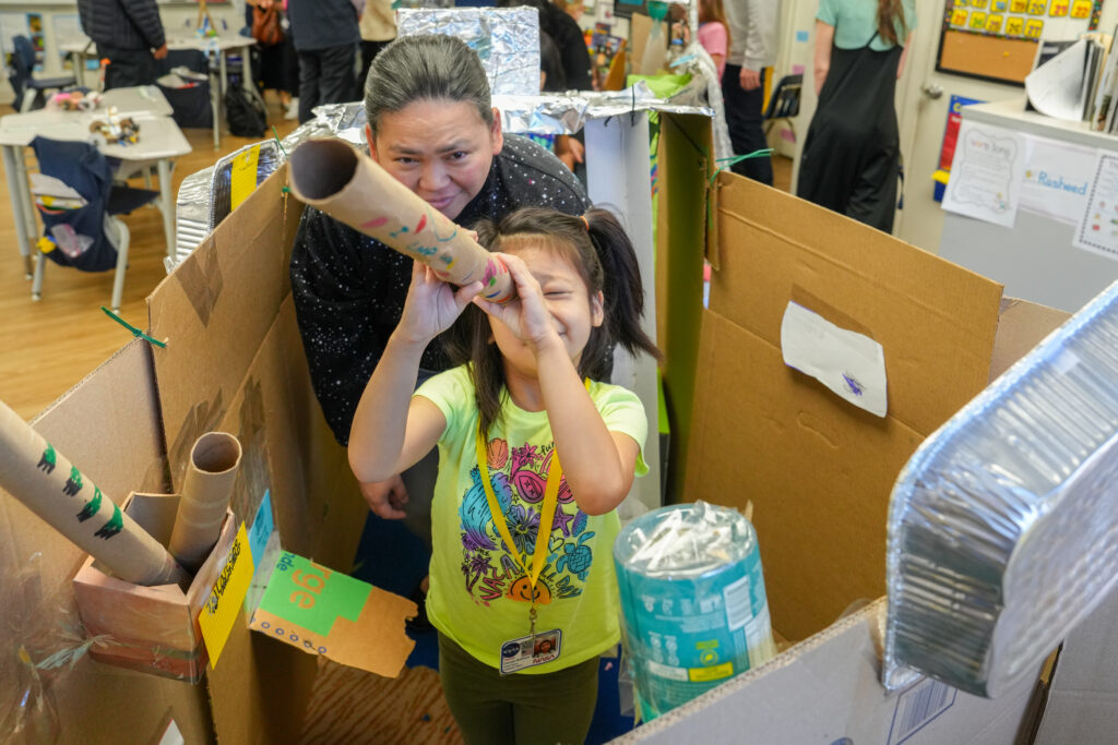 first grader being helped by a teacher