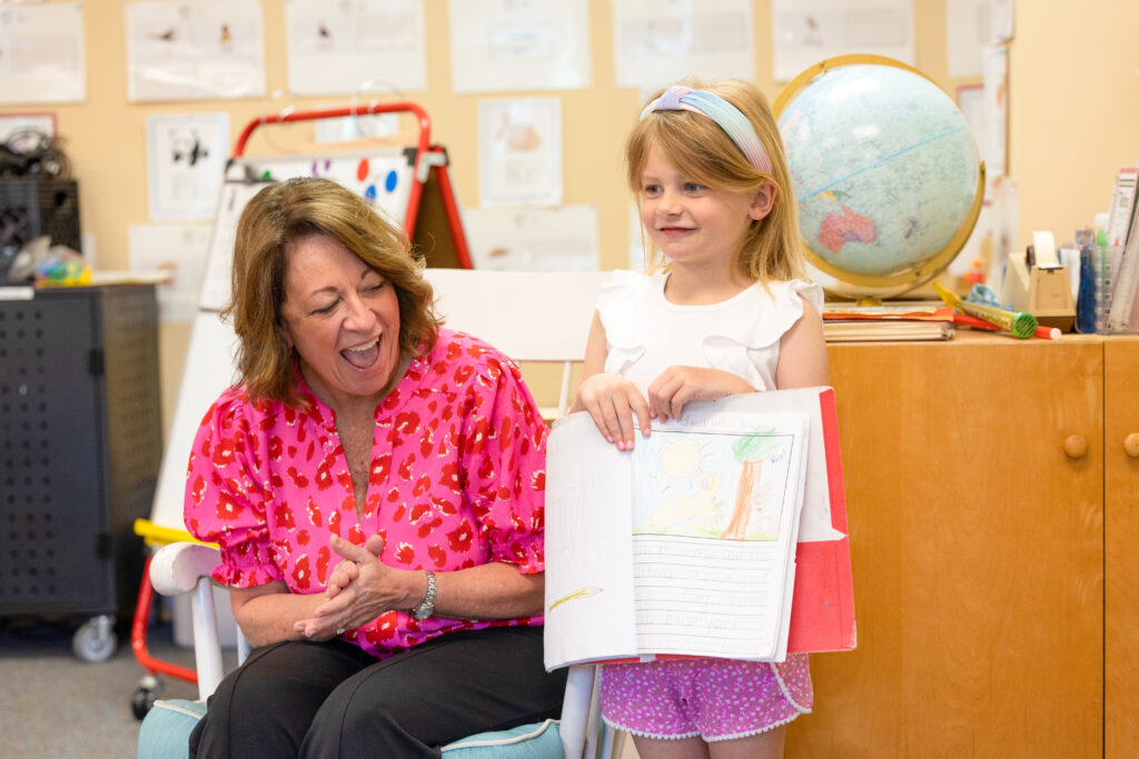 girl reading in front of her class